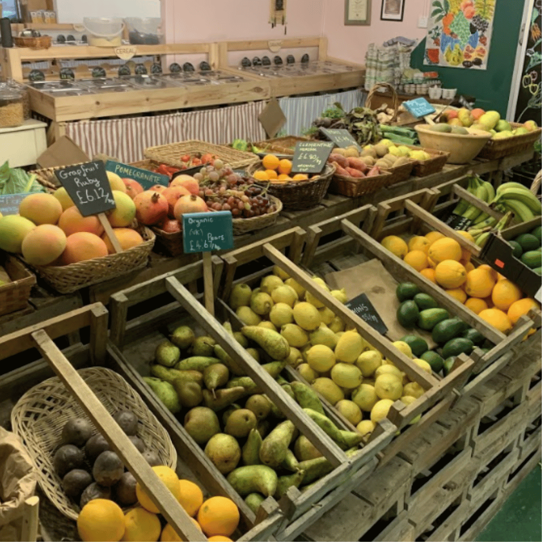 A refill shop showing crates of pick your own fruit and veg